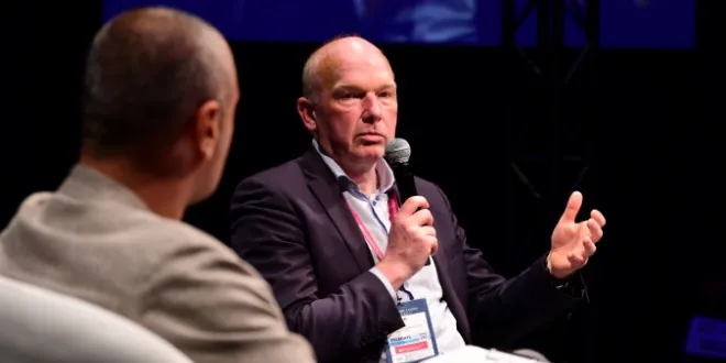 Maarten Haijer speaking with a microphone at an industry event